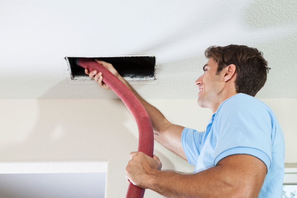 man cleaning air  ducts